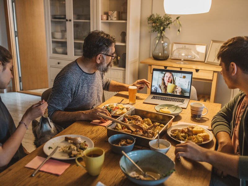 Man with hearing loss trying to hear at the dinner table with his family.