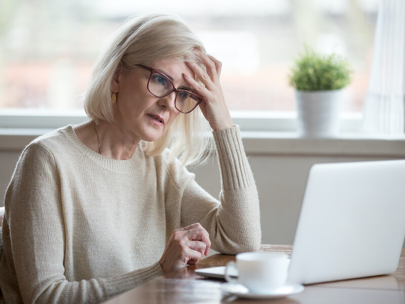 Confused mature business woman suffering from memory loss